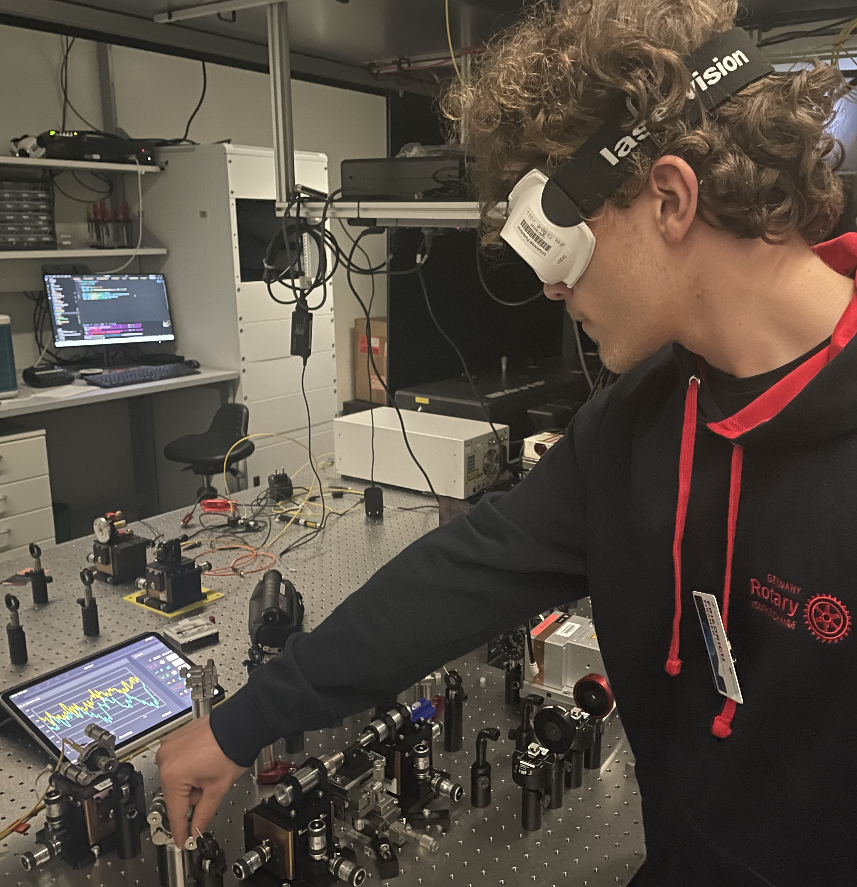 Working at an optical laboratory bench with protective glasses
